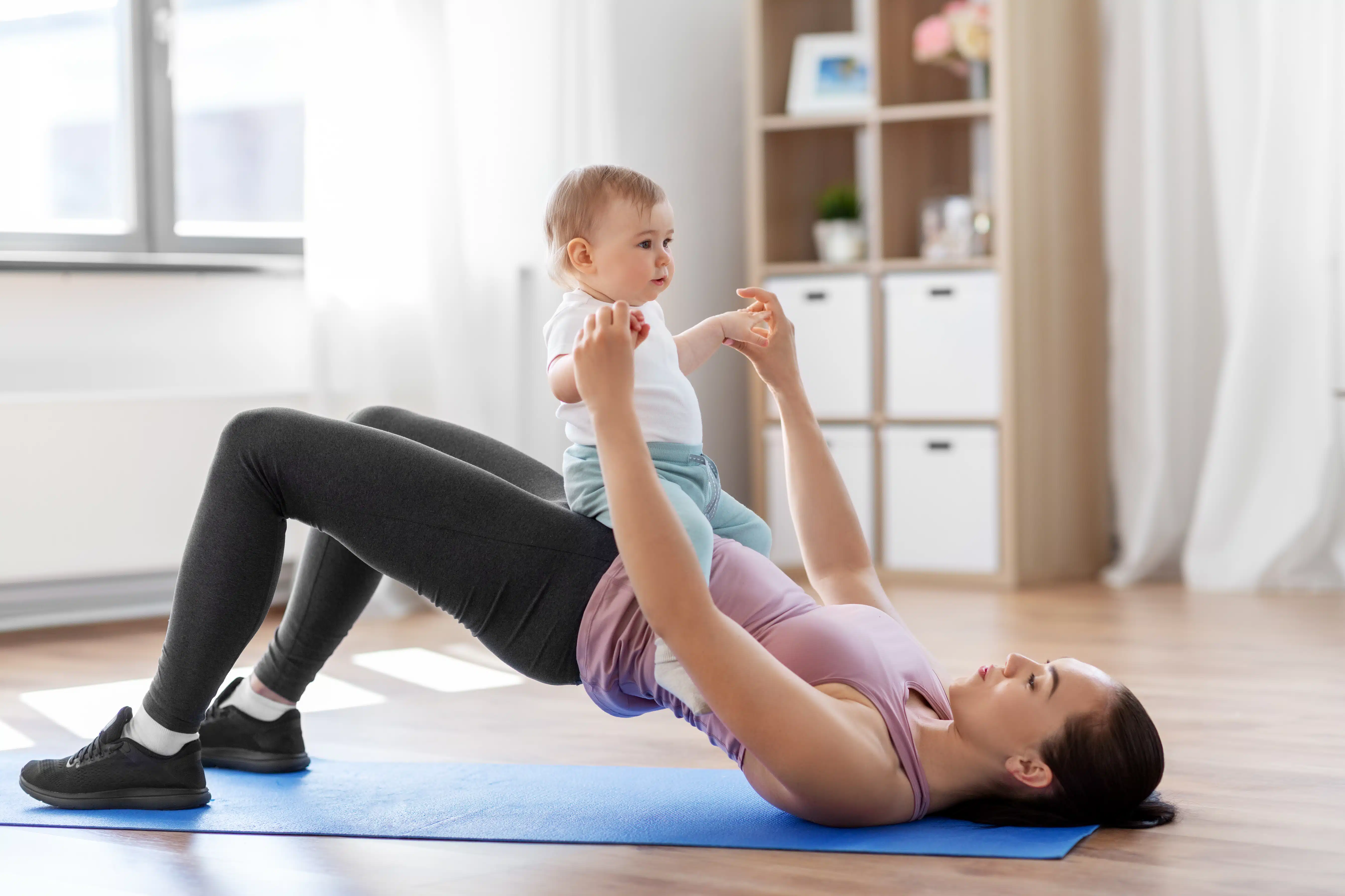 Mother doing pelvic floor exercise with child